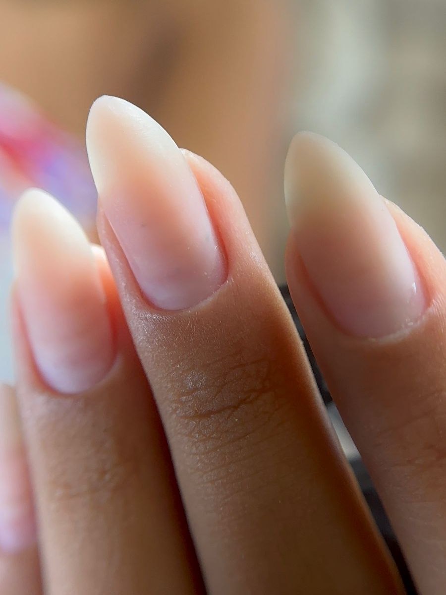 Unhas naturais em formato amendoado, com a região da cutícula limpa e a pele preservada